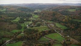 5.5K aerial stock footage flying over Route 14, farms, rural homes and small town, autumn, Bethel, Vermont Aerial Stock Footage | AX150_417E