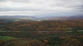 5.5K aerial stock footage flying by colorful forests and hills in autumn, overcast sky, Bethel, Vermont Aerial Stock Footage | AX150_421E