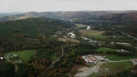 5.5K aerial stock footage flying over trailers, approaching White River, Route 107 in autumn, South Royalton, Vermont Aerial Stock Footage | AX150_423
