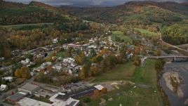 5.5K aerial stock footage orbiting small rural town, White River, small bridge, autumn, South Royalton, Vermont Aerial Stock Footage | AX150_430E