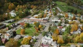 5.5K aerial stock footage orbiting town square, row of shops, colorful foliage in small town, autumn, South Royalton, Vermont Aerial Stock Footage | AX150_437