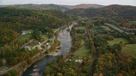 5.5K aerial stock footage flying over roads, approach White River and bridge, autumn, South Royalton, Vermont Aerial Stock Footage | AX150_450E