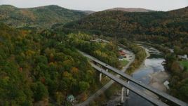 5.5K aerial stock footage flying over White River, approach Interstate 89, small bridge, pan left, autumn, South Royalton, Vermont Aerial Stock Footage | AX150_452