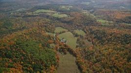 5.5K aerial stock footage flying over brightly colored forest, approaching a farm, autumn, Quechee, Vermont Aerial Stock Footage | AX150_464E
