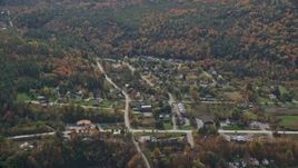 5.5K aerial stock footage flying by a small rural town, colorful foliage, autumn, cloudy, Quechee, Vermont Aerial Stock Footage | AX150_468E