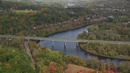 5.5K aerial stock footage flying by Interstate 89, small bridge, Connecticut River, autumn, Lebanon, New Hampshire Aerial Stock Footage | AX150_474E