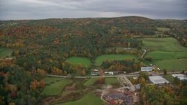 5.5K aerial stock footage flying over Hartland Road, approach colorful forested hills, autumn, White River Junction, Vermont Aerial Stock Footage | AX151_001