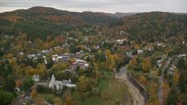 5.5K aerial stock footage flying by Ottauquechee River, small rural town, overcast, autumn, Woodstock, Vermont Aerial Stock Footage | AX151_014E