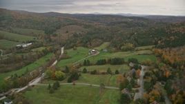 5.5K aerial stock footage flying over rural homes, approaching colorful forests, hills, autumn, Woodstock, Vermont Aerial Stock Footage | AX151_023E