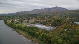 5.5K aerial stock footage flying over Connecticut River, approaching small town, autumn, Windsor, Vermont Aerial Stock Footage | AX151_055E
