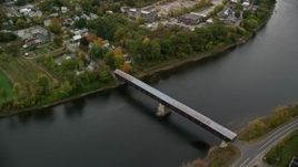 5.5K aerial stock footage flying by covered bridge, Connecticut River, colorful trees, autumn, Windsor, Vermont Aerial Stock Footage | AX151_058E