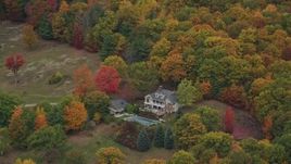 5.5K aerial stock footage flying away from isolated homes, brightly colored trees, autumn, Cornish, New Hampshire Aerial Stock Footage | AX151_068