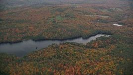 5.5K aerial stock footage approaching Red Leaf Pond, colorful forest, autumn, overcast, Croydon, New Hampshire Aerial Stock Footage | AX151_074E
