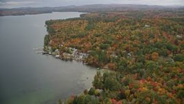 5.5K aerial stock footage flying by waterfront homes, colorful forest, Lake Sunapee, autumn, Newbury, New Hampshire Aerial Stock Footage | AX151_085E