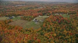 5.5K aerial stock footage flying by rural home, colorful trees, autumn, New London, New Hampshire Aerial Stock Footage | AX151_095