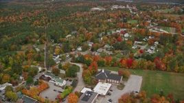 5.5K aerial stock footage flying by a small rural town with colorful foliage, autumn, New London, New Hampshire Aerial Stock Footage | AX151_102