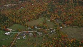 5.5K aerial stock footage approaching rural homes, overcast skies, colorful trees, autumn, Wilmot, New Hampshire Aerial Stock Footage | AX151_109E
