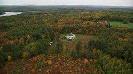 5.5K aerial stock footage approaching an isolated home and tilt down, autumn, Webster, New Hampshire Aerial Stock Footage | AX151_136