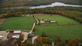 5.5K aerial stock footage flying by red barns, colorful foliage, autumn, Webster, New Hampshire Aerial Stock Footage | AX151_137E