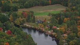 5.5K aerial stock footage flying by waterfront homes, Contoocook River, autumn, Penacook, New Hampshire Aerial Stock Footage | AX151_141