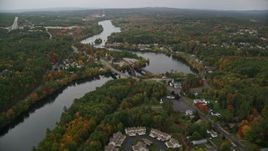 5.5K aerial stock footage orbiting small bridges, Merrimack River, small town, autumn, Hooksett, New Hampshire Aerial Stock Footage | AX152_012E