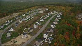 5.5K aerial stock footage flying by tract homes, colorful foliage in autumn, Hooksett, New Hampshire Aerial Stock Footage | AX152_020