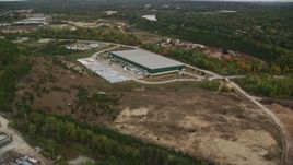 5.5K aerial stock footage over quarry, approach warehouse building, autumn, Hooksett, New Hampshire Aerial Stock Footage | AX152_029E