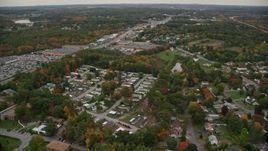 5.5K aerial stock footage flying by mobile home park, stores, autumn, Salem, New Hampshire Aerial Stock Footage | AX152_082