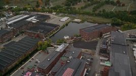 5.5K aerial stock footage approaching factories, pan right and tilt down, autumn, Methuen, Massachusetts Aerial Stock Footage | AX152_086