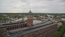 5.5K aerial stock footage of a factory and clock tower by the water, overcast, Lawrence, Massachusetts Aerial Stock Footage | AX152_102E