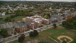 5.5K aerial stock footage approaching a park and high school among partial fall foliage, Lawrence, Massachusetts Aerial Stock Footage | AX152_107E