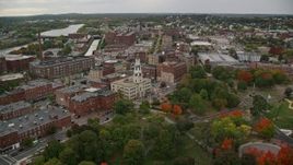 5.5K aerial stock footage flying over park with partial fall foliage toward City Hall, autumn, Lawrence, Massachusetts Aerial Stock Footage | AX152_110E