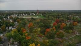 5.5K aerial stock footage flying over fall trees toward a cemetery and water tower, autumn, Lawrence, Massachusetts Aerial Stock Footage | AX152_113E
