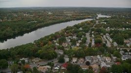 5.5K aerial stock footage flying over town among fall foliage toward a river, autumn, Methuen, Massachusetts Aerial Stock Footage | AX152_117