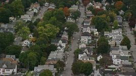 5.5K aerial stock footage flying over neighborhood and trees with partial fall foliage, Lowell, Massachusetts Aerial Stock Footage | AX152_143