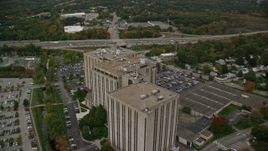 5.5K aerial stock footage flying over and away from an office building, autumn, Lowell, Massachusetts Aerial Stock Footage | AX152_148