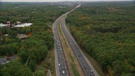 5.5K aerial stock footage following a highway bordered by fall foliage toward an overpass, Billerica, Massachusetts Aerial Stock Footage | AX152_162E