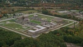 5.5K aerial stock footage flying high over Massachusetts Correctional Institution at Norfolk, with autumn trees, Massachusetts Aerial Stock Footage | AX152_213