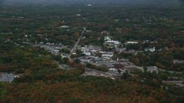 5.5K aerial stock footage flying over fall foliage toward small town shops, Walpole, Massachusetts Aerial Stock Footage | AX152_230