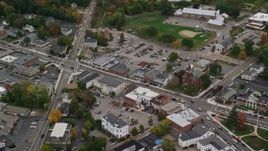 5.5K aerial stock footage flying over fall foliage toward small town shops, Walpole, Massachusetts Aerial Stock Footage | AX152_230E