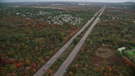 5.5K aerial stock footage of an Interstate near neighborhood nestled among fall foliage, Canton, Massachusetts Aerial Stock Footage | AX152_233E