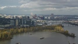 5.5K aerial stock footage flying over Willamette River looking at downtown skyline, partly cloudy, autumn, Southwest Portland, Oregon Aerial Stock Footage | AX153_014E