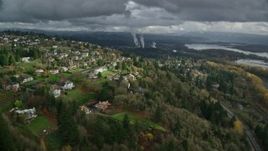 5.5K aerial stock footage flying over Highway 14 by suburban homes to approach paper mill in Camas, Washington Aerial Stock Footage | AX153_146E
