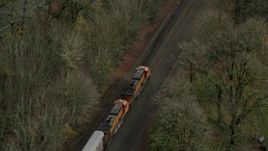 5.5K aerial stock footage of a bird's eye tracking a train traveling into Columbia River Gorge, Oregon Aerial Stock Footage | AX153_180E