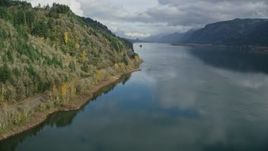5.5K aerial stock footage of train tracks at the bottom of a cliff in Columbia River Gorge, Oregon Aerial Stock Footage | AX154_001E