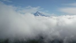 5.5K aerial stock footage flying over thick clouds toward the summit of Mount Hood, Cascade Range, Oregon Aerial Stock Footage | AX154_061
