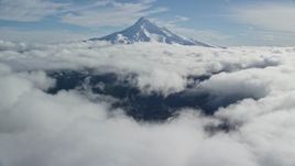 5.5K aerial stock footage approaching snowy summit while flying over clouds, Mount Hood, Cascade Range, Oregon Aerial Stock Footage | AX154_066E
