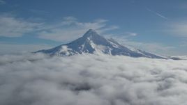 5.5K aerial stock footage of the summit of Mount Hood with snow and low clouds, Mount Hood, Cascade Range, Oregon Aerial Stock Footage | AX154_070