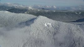 5.5K aerial stock footage approaching a snow covered mountain ridge and forest in the Cascade Range, Oregon Aerial Stock Footage | AX154_100