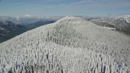 5.5K aerial stock footage flying over frozen forest on a mountain ridge, Cascade Range, Oregon Aerial Stock Footage | AX154_103E